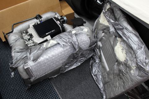 2003 Ford Crown Victoria - Kenne Bell supercharger with intercooler sits on bubble-wrap and foil padding pulled from its box.