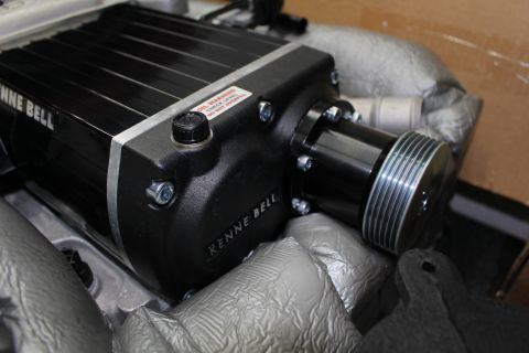 2003 Ford Crown Victoria - Close view of a Kenne Bell supercharger's silver multi-groove drive pulley, oil-fill cap and red warning label.