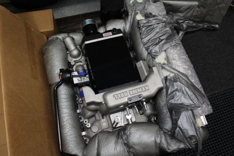 2003 Ford Crown Victoria - Top-down view of a Kenne Bell supercharger assembly with intercooler core and intake manifold packed in foam inside a box.