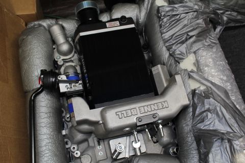 2003 Ford Crown Victoria - Kenne Bell supercharger assembly showing the black intercooler core and cast aluminum manifold resting in foam packing.