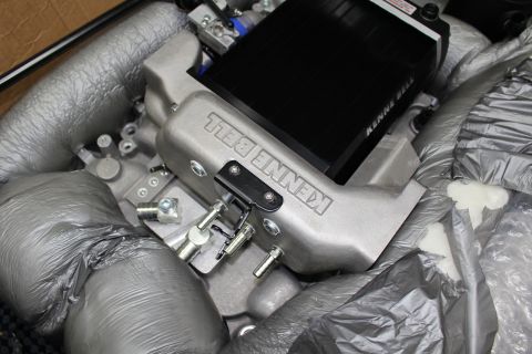 2003 Ford Crown Victoria - cast aluminum Kenne Bell intake manifold with throttle linkage and intercooler core viewed from above in foam packing.