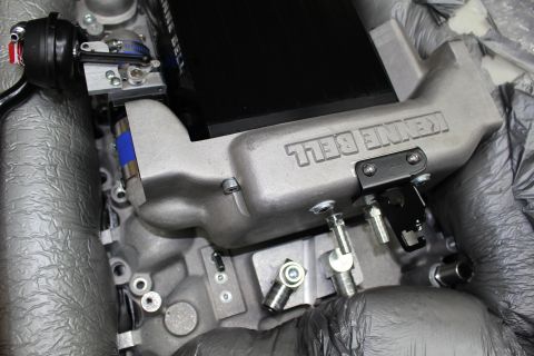 2003 Ford Crown Victoria - Side view of a Kenne Bell cast aluminum intake manifold with throttle linkage and the supercharger casing above it.