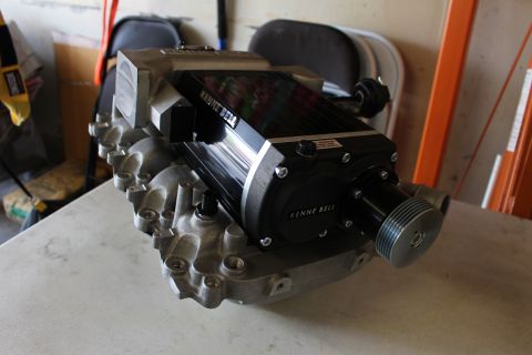 2003 Ford Crown Victoria - Kenne Bell supercharger on its aluminum manifold sits on a white bench in a garage with an orange ladder behind it.