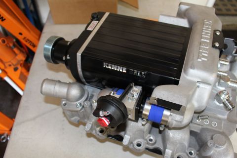 2003 Ford Crown Victoria - black Kenne Bell supercharger with a ribbed snout pulley, blue silicone coupler and bypass actuator sits on a cast manifold base.