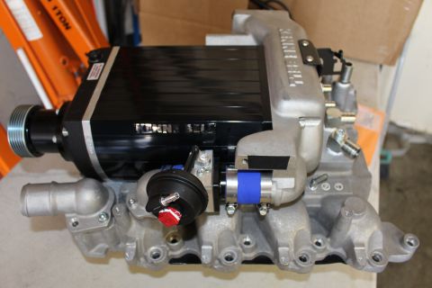 2003 Ford Crown Victoria - black Kenne Bell twin-screw supercharger with finned case and ribbed snout pulley mounted on a cast-aluminum intake manifold.