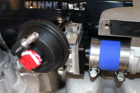 2003 Ford Crown Victoria - detail shot of a Kenne Bell supercharger showing the embossed name, a red-tagged actuator and a blue silicone coupler with hose clamps.