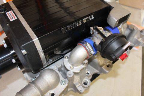 2003 Ford Crown Victoria - close view of a Kenne Bell supercharger discharge area with blue silicone couplers, a cast elbow and a black bypass actuator.