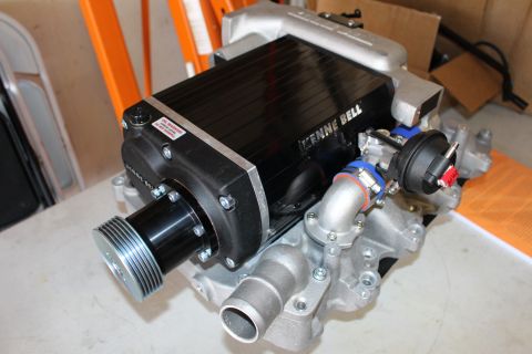 2003 Ford Crown Victoria - assembled black Kenne Bell supercharger with snout pulley, inlet elbow and bypass actuator mounted on a cast-aluminum manifold.