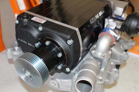 2003 Ford Crown Victoria - close view of a Kenne Bell supercharger nose drive showing the bolted cover plate, polished ribbed pulley and blue discharge coupler.