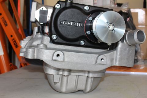 2003 Ford Crown Victoria - Kenne Bell twin-screw supercharger mounted to a cast aluminum intake manifold sits on a workbench near an orange ladder.