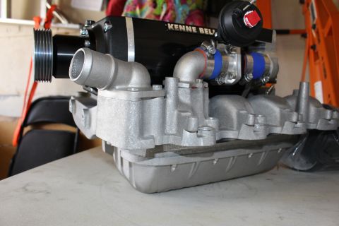 2003 Ford Crown Victoria - Kenne Bell supercharger with drive pulley, throttle inlet, and blue silicone couplers fully assembled on an aluminum intake manifold.
