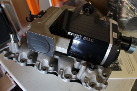 2003 Ford Crown Victoria - Three-quarter view of a Kenne Bell supercharger with its throttle inlet and drive pulley bolted to an aluminum intake manifold.