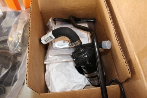 2003 Ford Crown Victoria - small black electric pump with a curved hose and bagged hardware packed inside a cardboard shipping box.
