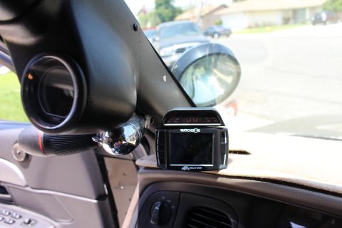 2003 Ford Crown Victoria - black A-pillar boost gauge and a dash-mounted Watchdog radar detector sit atop a sedan's dashboard.
