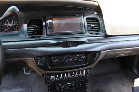 2003 Ford Crown Victoria - Front dashboard view showing a tachometer, Pioneer touchscreen head unit, rotary climate controls, and a custom switch panel below.