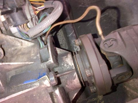 1994 Ford Bronco - Transfer case and driveshaft connection with visible wiring harness and metal components.