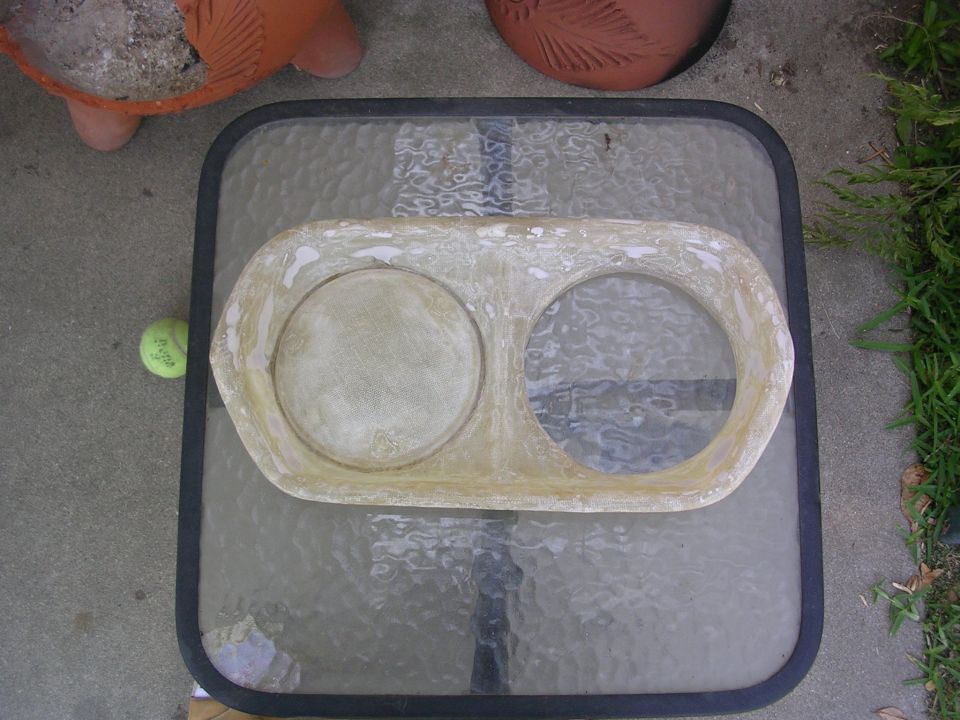 Fiberglass dash insert with two circular openings, possibly for gauges