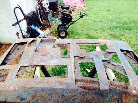 1979 Ford Bronco - This heavily rusted metal frame, likely a vehicle part, is in poor condition and shows significant decay.