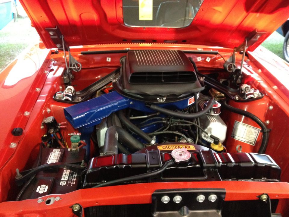 1970 Ford Mustang engine bay with hood open, showing V8 engine and scoop