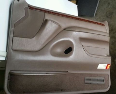 1994 Ford Bronco - Driver's side door panel from a 1994 Ford Bronco, showing interior trim details.