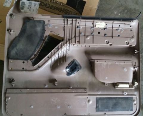 1994 Ford Bronco - This is a disassembled vehicle door panel, showing the internal structure and mounting points.