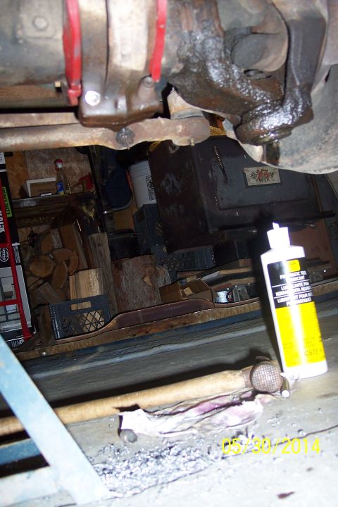 1978 Ford Bronco - Close-up view of vehicle undercarriage components, including red suspension parts and greasy areas.