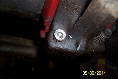 1978 Ford Bronco - Detail of a mechanical part, possibly from an engine, showing a bolt and threaded fastener.