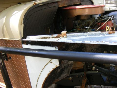 1978 Ford Bronco engine bay showing carburetor, distributor, and inner fender