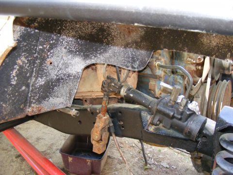 Rusty U-joint and steering gear assembly on a vehicle frame