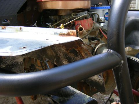 Engine bay with roll cage and exposed metal