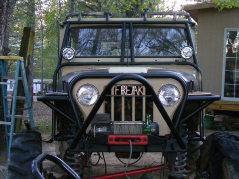 Modified Jeep with "FREAK" grille, winch, and large tires