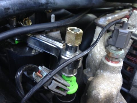 2002 Ford Mustang - Fuel injector and sensor assembly, likely from a car's engine bay.