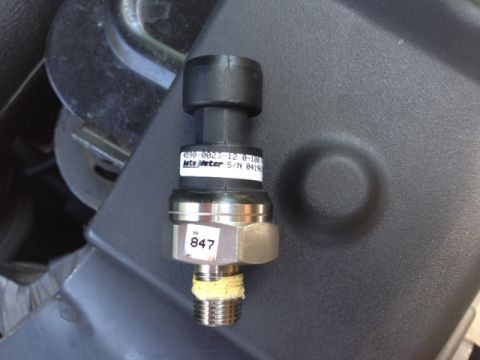 2002 Ford Mustang - A close-up view of an automotive sensor, likely a pressure sensor, with visible part and serial numbers.