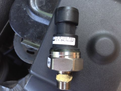 2002 Ford Mustang - A close-up view of a pressure sensor with visible part numbers and serial information.