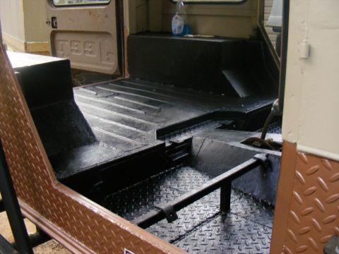 Interior of a vehicle with black painted floor and diamond plate trim