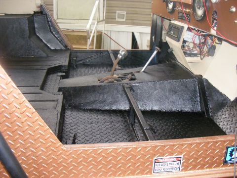 Interior of a vehicle with diamond plate flooring and a stick shift