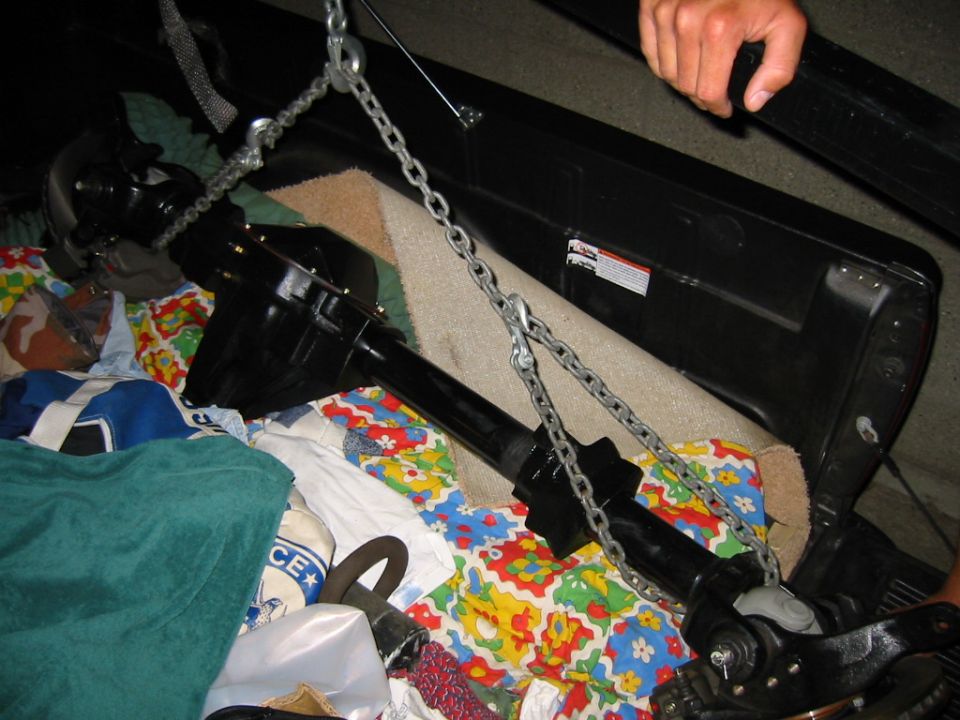 Black differential and axle assembly secured with chains, resting on blankets