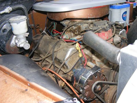 Engine bay showing alternator, brake master cylinder, carburetor, and battery. Supermotors.net logo visible