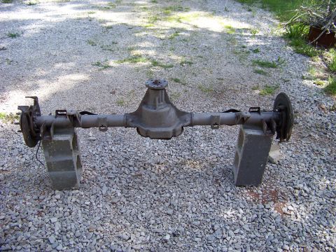 1999 Mercury Grand Marquis - A rear axle assembly, likely from a sedan, is shown resting on cinder blocks outdoors.