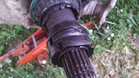 1979 Ford Bronco - A close-up view of a vehicle's driveshaft joint, showing wear and grease.