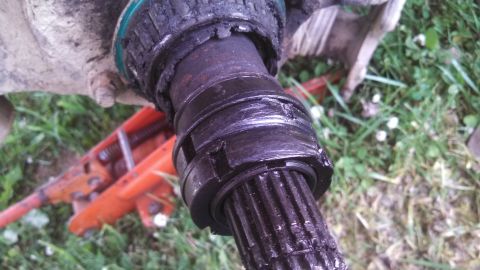1979 Ford Bronco - A close-up view of a damaged driveshaft joint, showing wear and tear on the metal components.