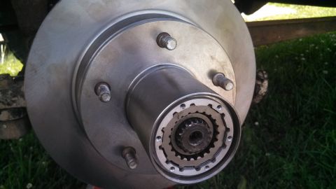 1979 Ford Bronco - A detailed view of a vehicle's front wheel hub assembly, showing the brake rotor and the internal splined mechanism.