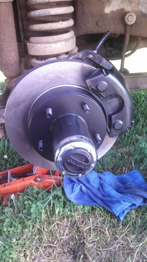 1979 Ford Bronco - The vehicle's brake system is shown with a new rotor and caliper, and a locking hub is visible.