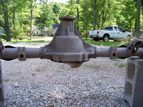 1999 Mercury Grand Marquis - A rear axle assembly is shown in detail, with a white pickup truck visible in the background.