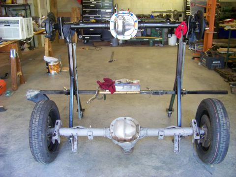 1999 Mercury Grand Marquis - Rear axle assembly with wheels, set up on stands in a workshop.