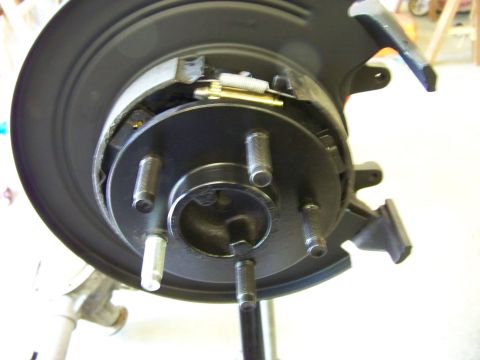 1999 Mercury Grand Marquis - Close-up view of a vehicle's rear brake drum and internal assembly, showing brake shoes and springs.