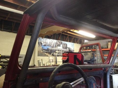 1985 Jeep CJ7 - Interior view of a 1985 Jeep CJ7, highlighting the custom roll cage and steering wheel.