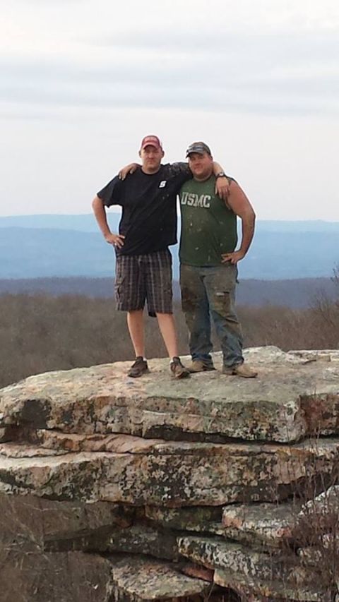 1979 Ford Bronco - Two men pose for a photo on a rocky outcrop, with a vast landscape stretching out behind them.