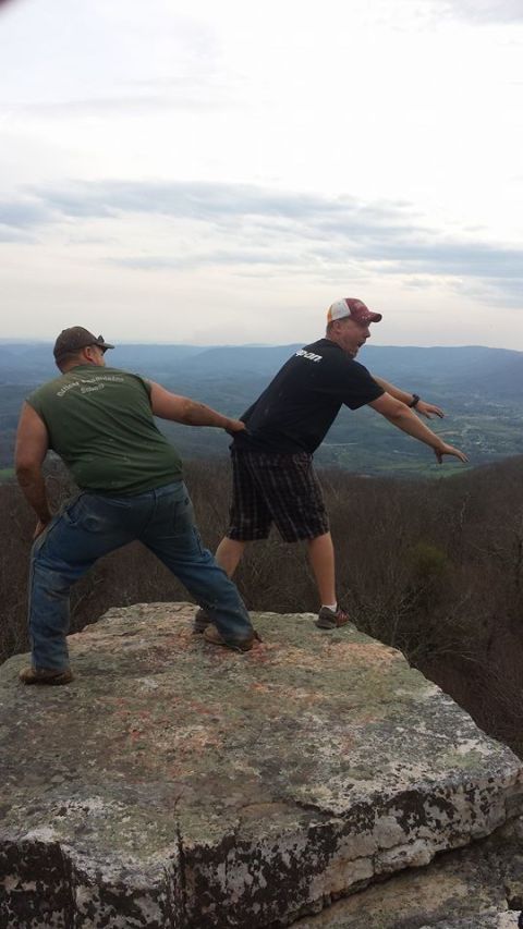 1979 Ford Bronco - Two men pose on a rock overlooking a valley, with a scenic landscape in the background.