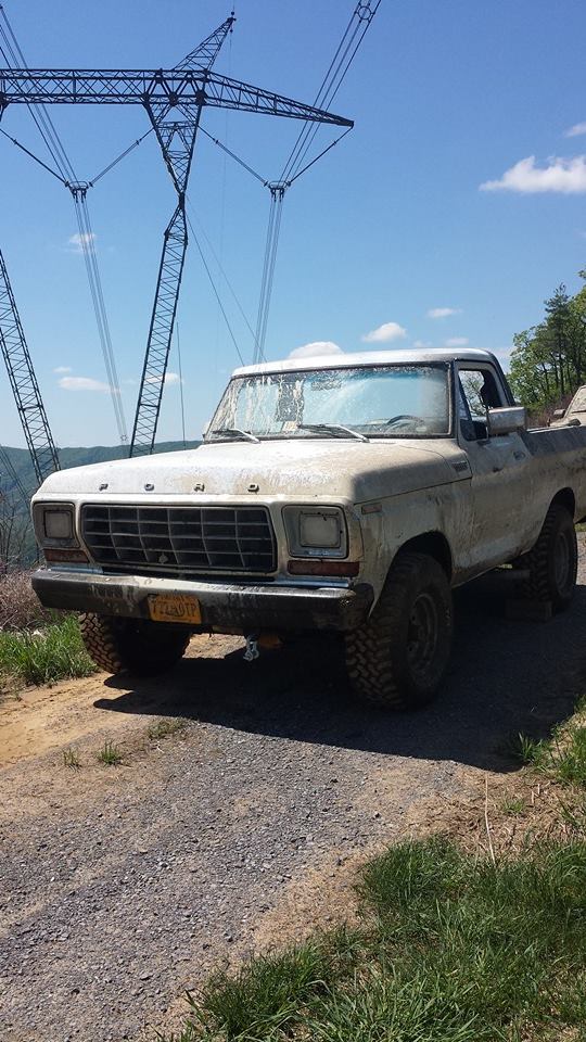 1979 Ford F-150 truck, 3q-front view, dirty white exterior, on gravel road